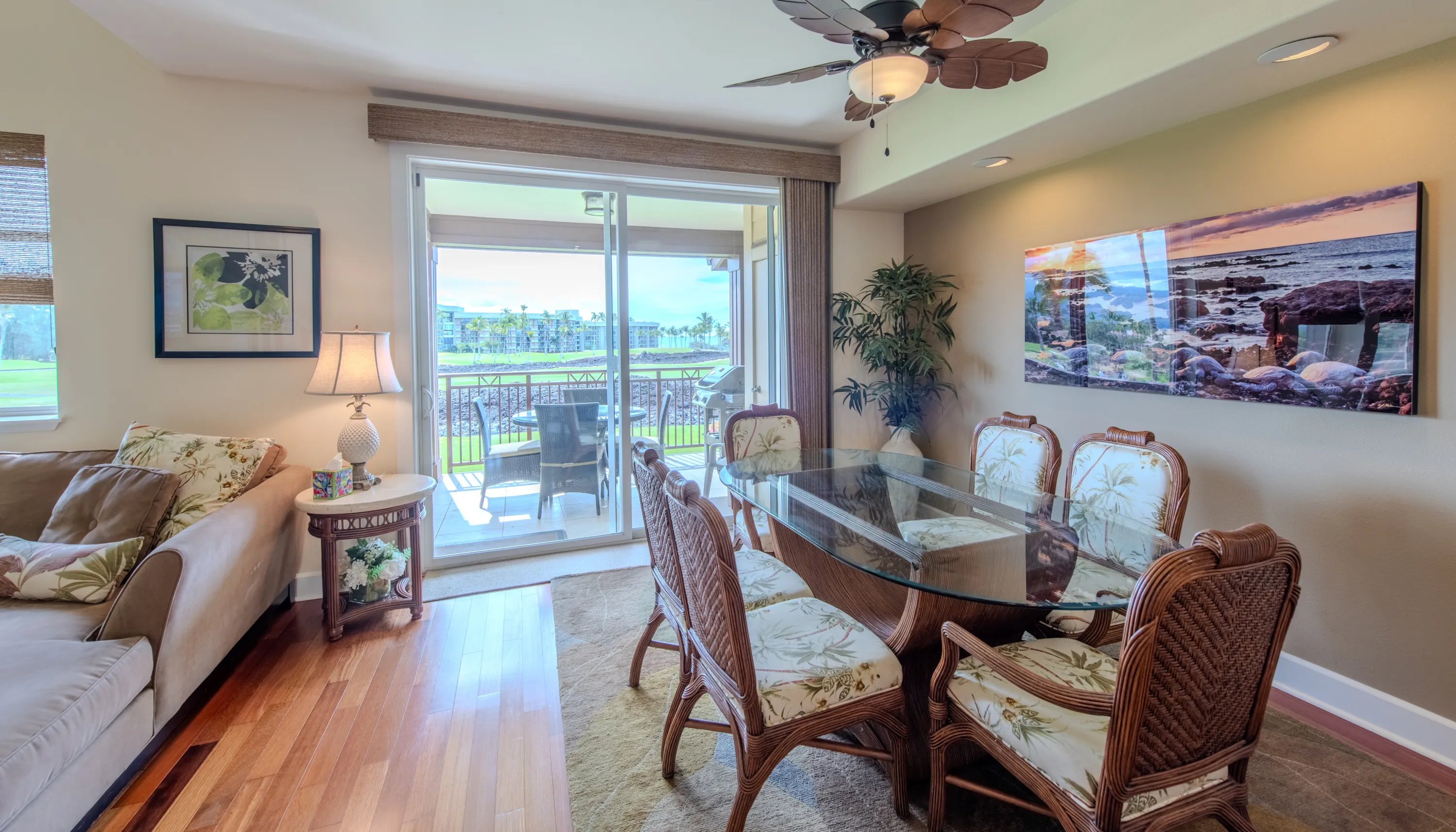 Glass dining table for six beside the lanai and golf-course view