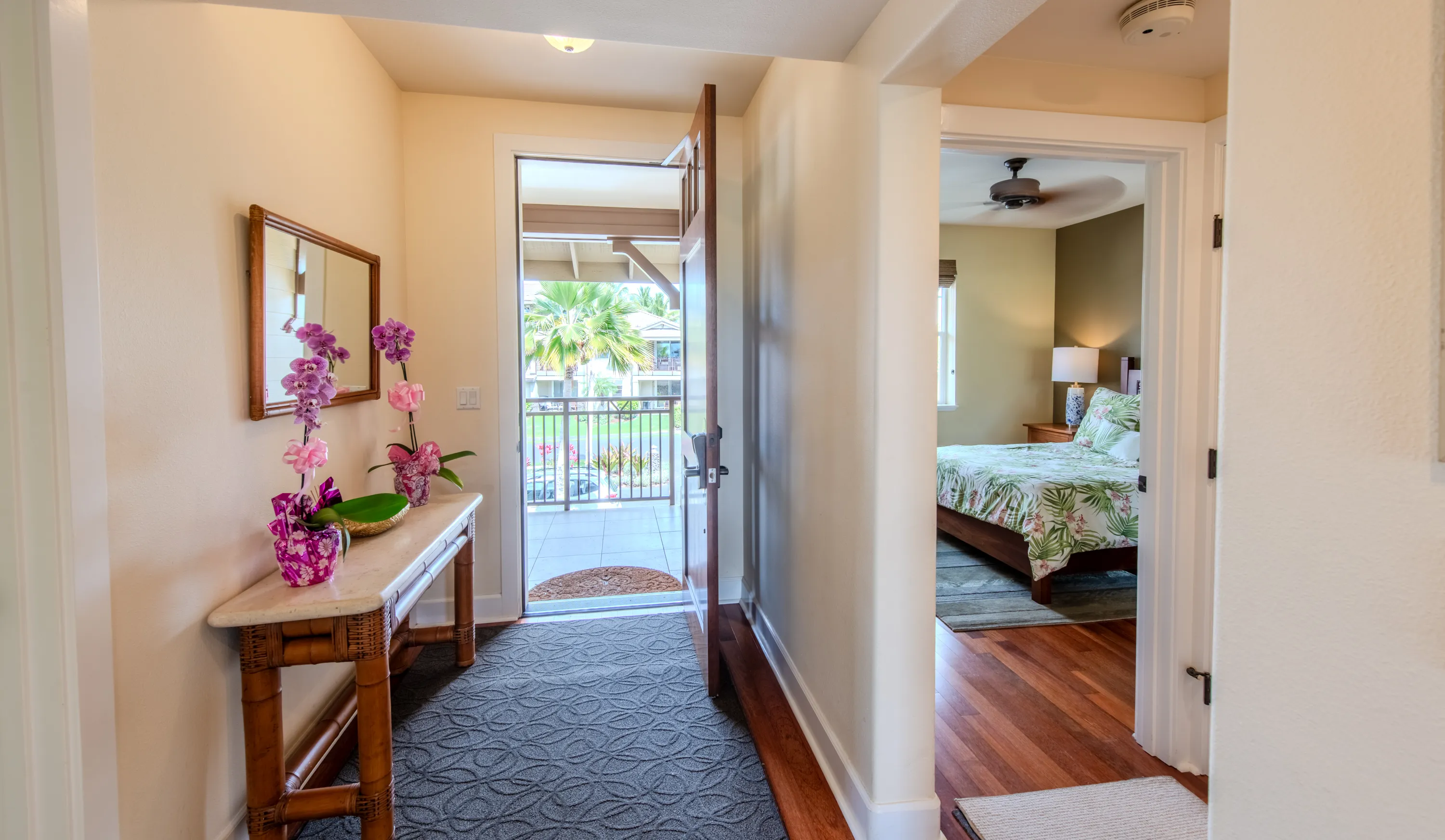 Entry hallway with a console table opening to a bedroom and the lanai