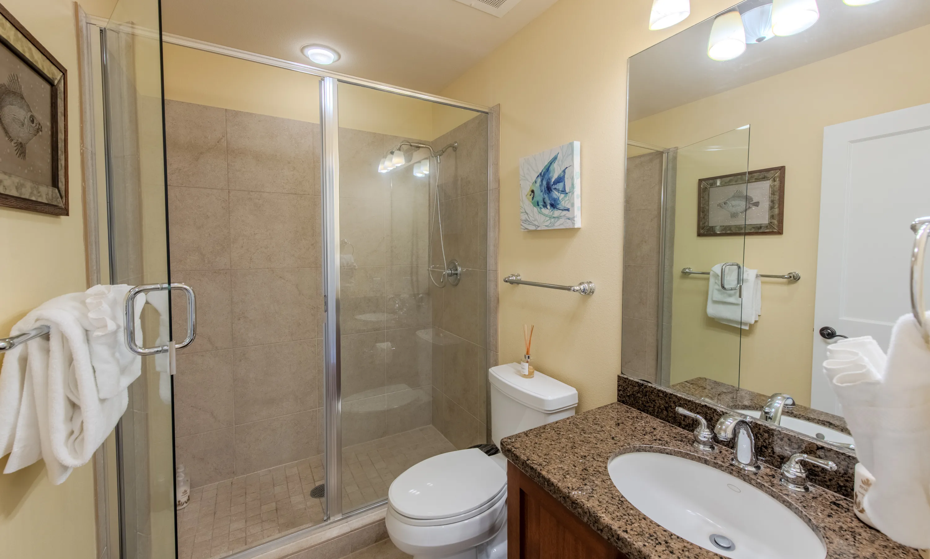 Bathroom with a glass walk-in shower and granite vanity