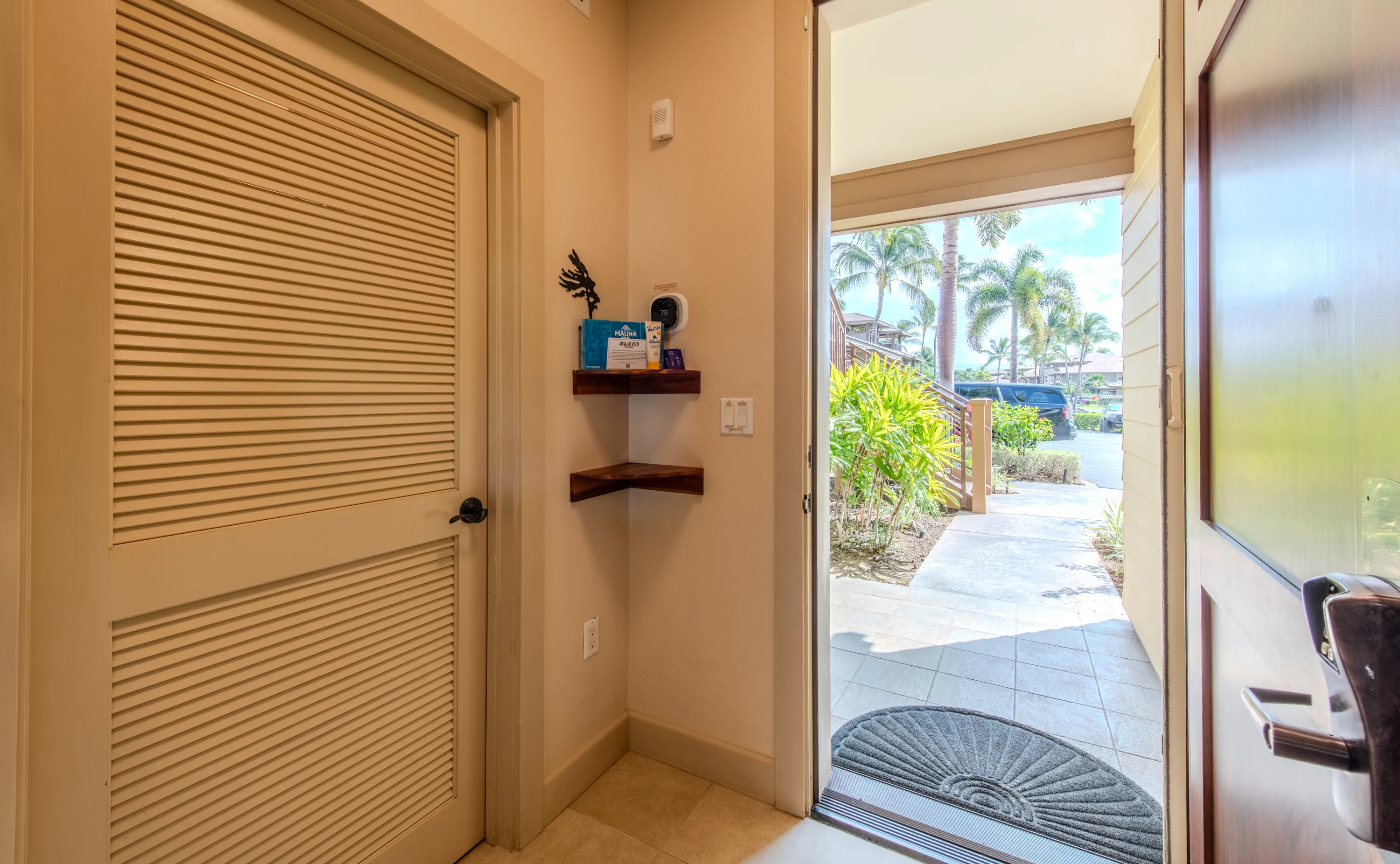 Entry opening to a lanai framed by palms