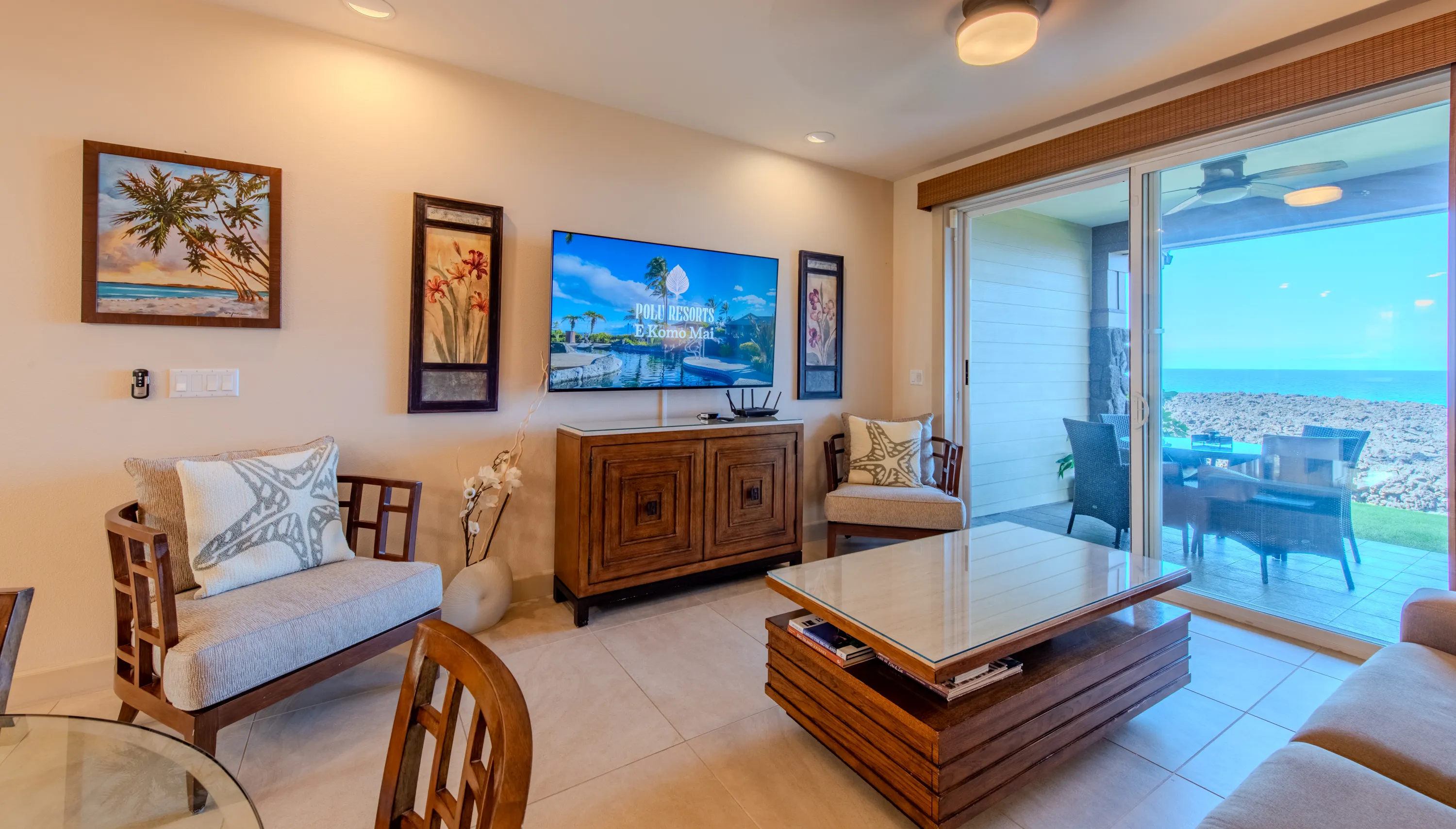 Living area with lounge seating opening to the ocean-view lanai