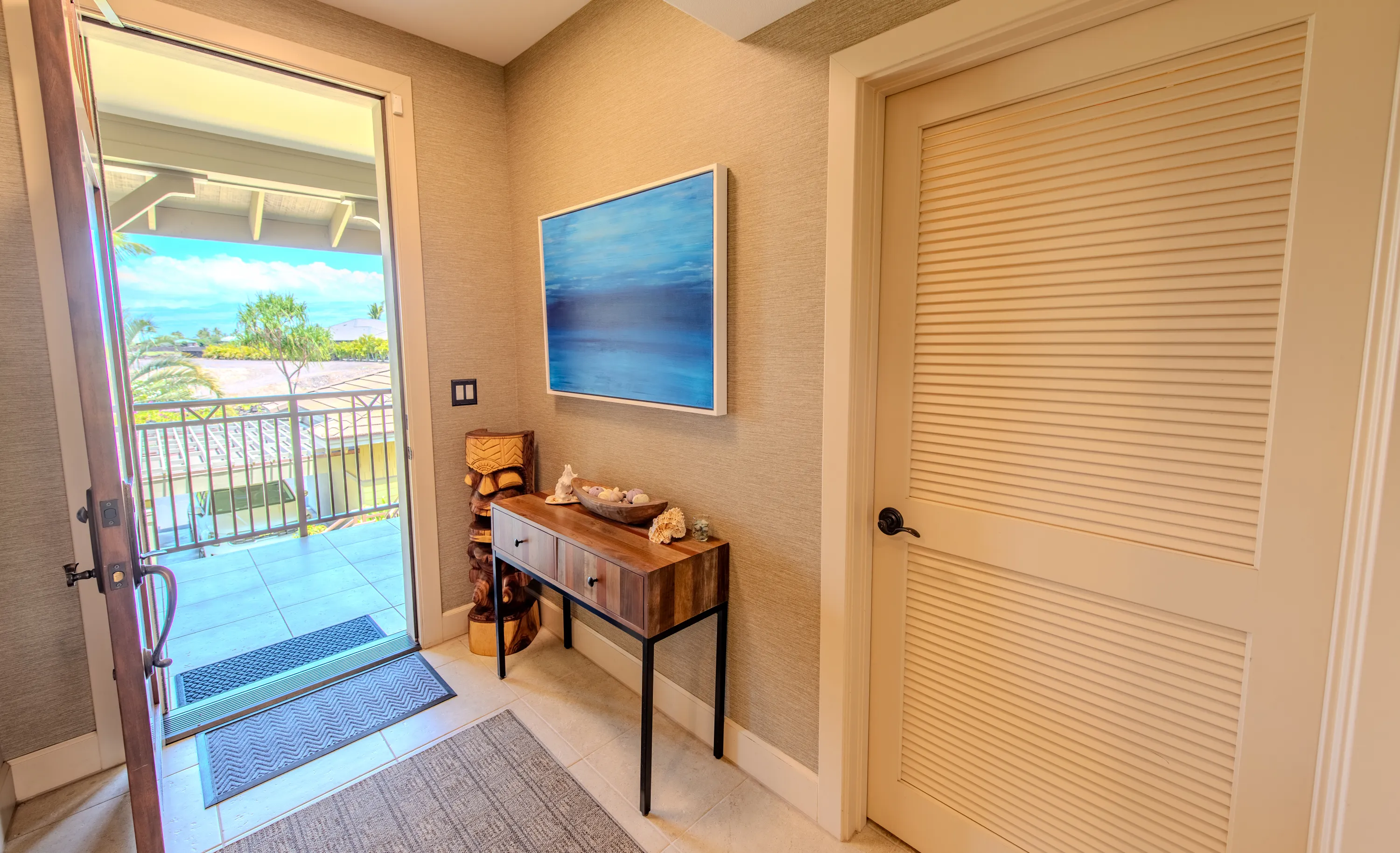 Entry with a console table and doors opening to the trade-wind breeze
