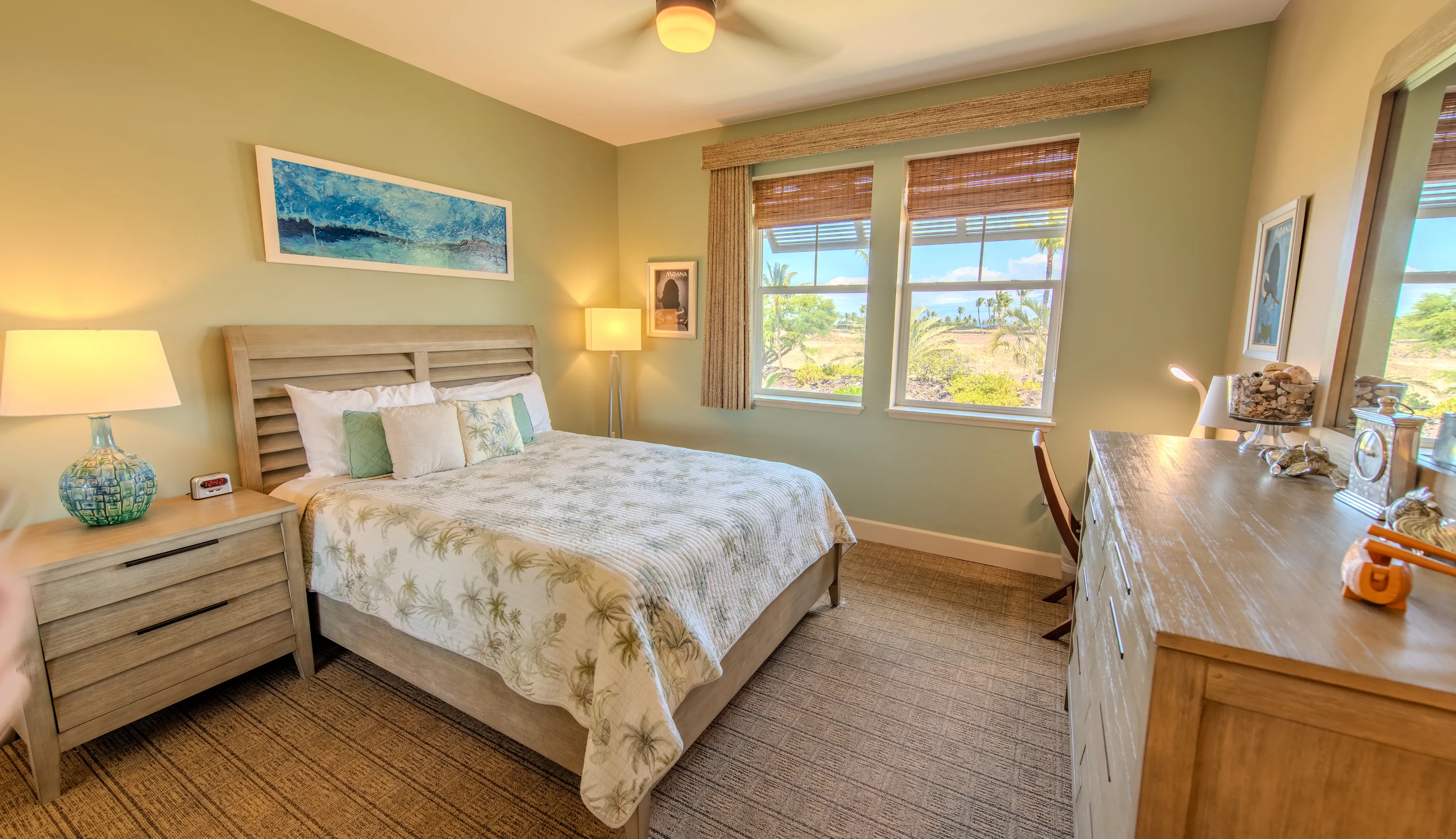 Third bedroom with a floral bedspread and garden outlook