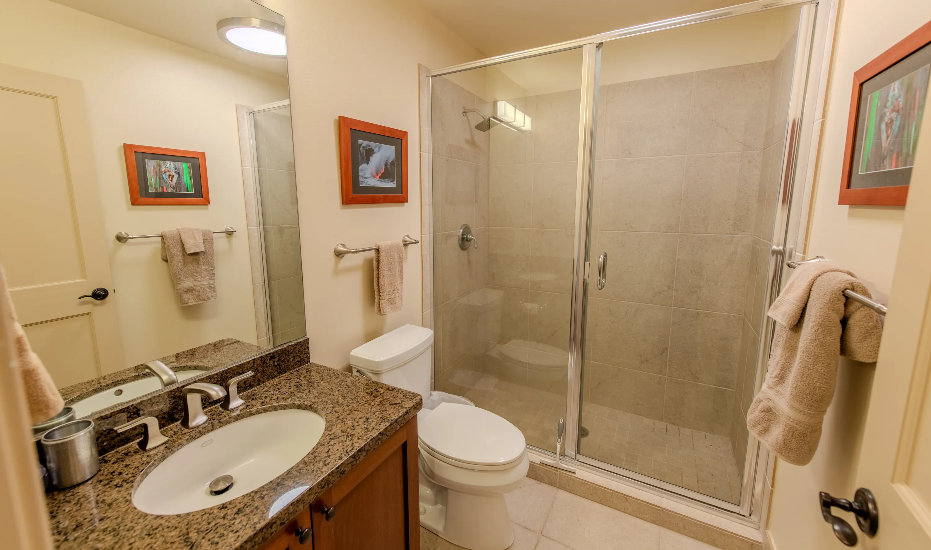 Guest bathroom with a glass walk-in shower and granite vanity