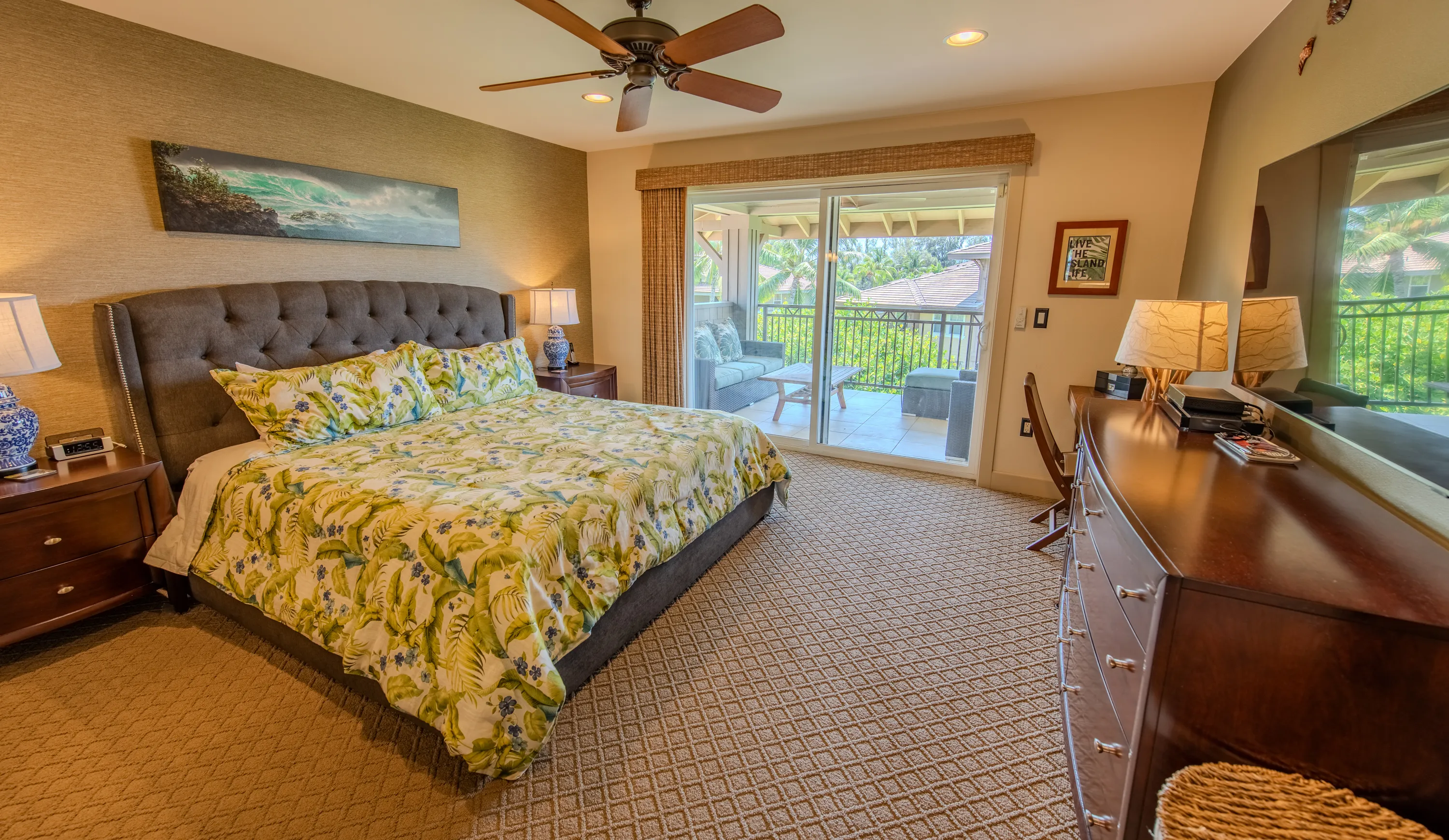 Primary bedroom with island-floral bedding and private lanai access