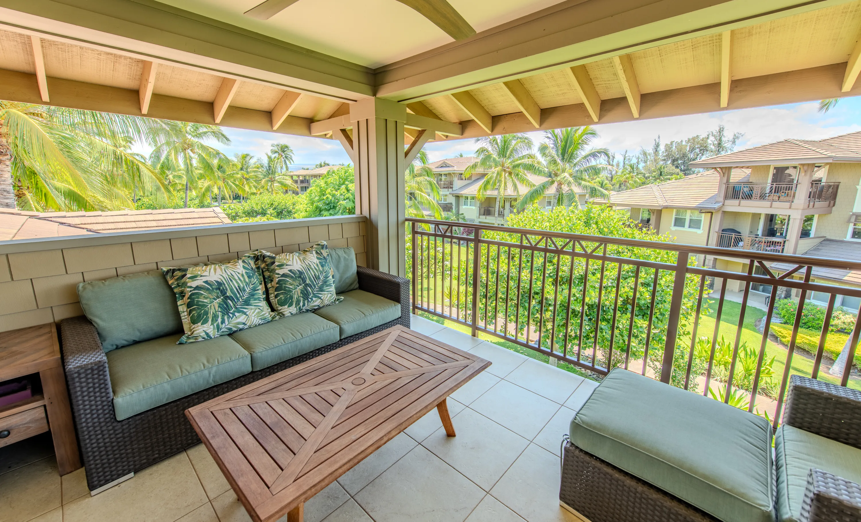 Private upstairs lanai of a Hali'i Kai suite with lounge seating overlooking the palms