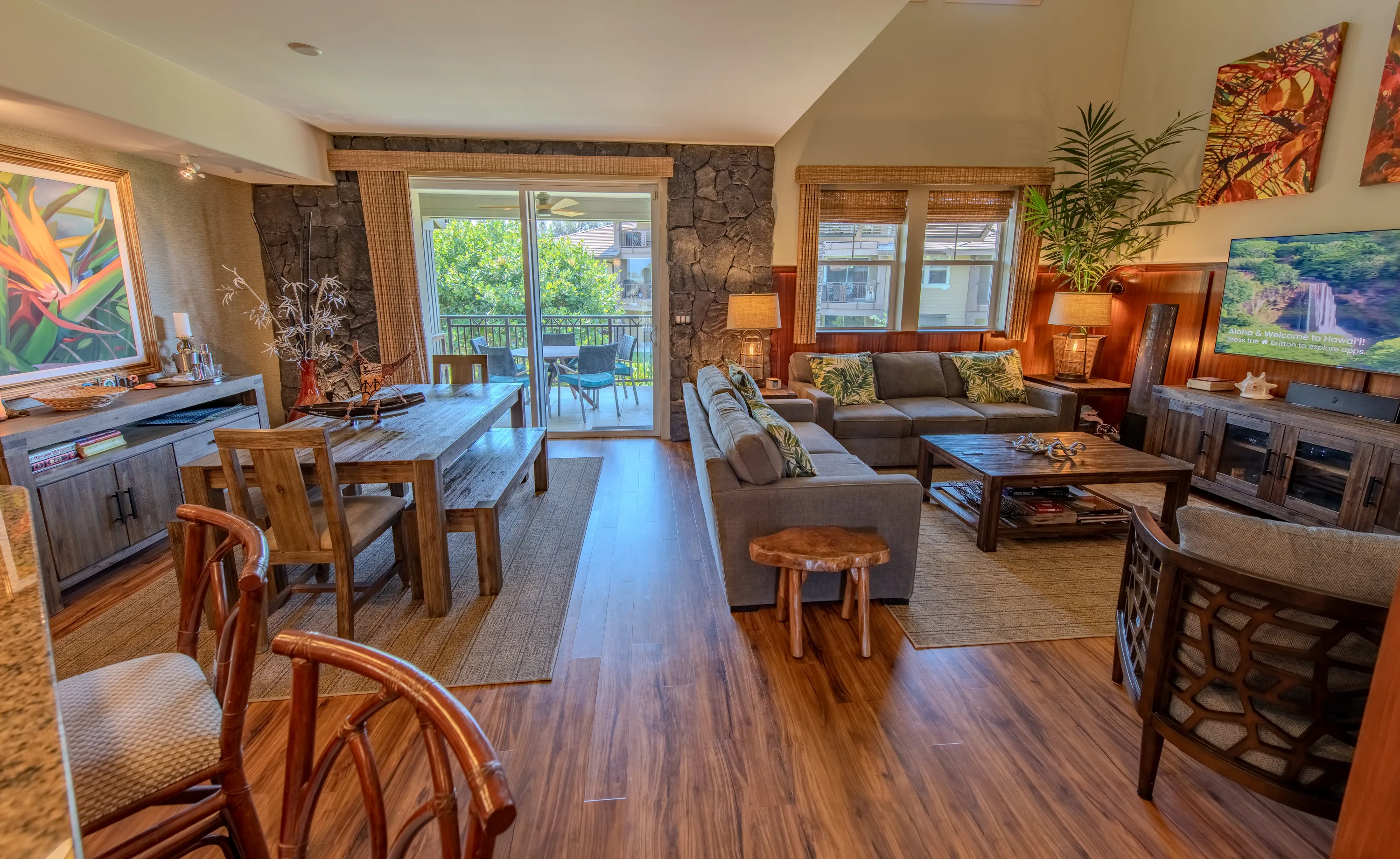 Open living area with sofas and sliding doors to the lanai