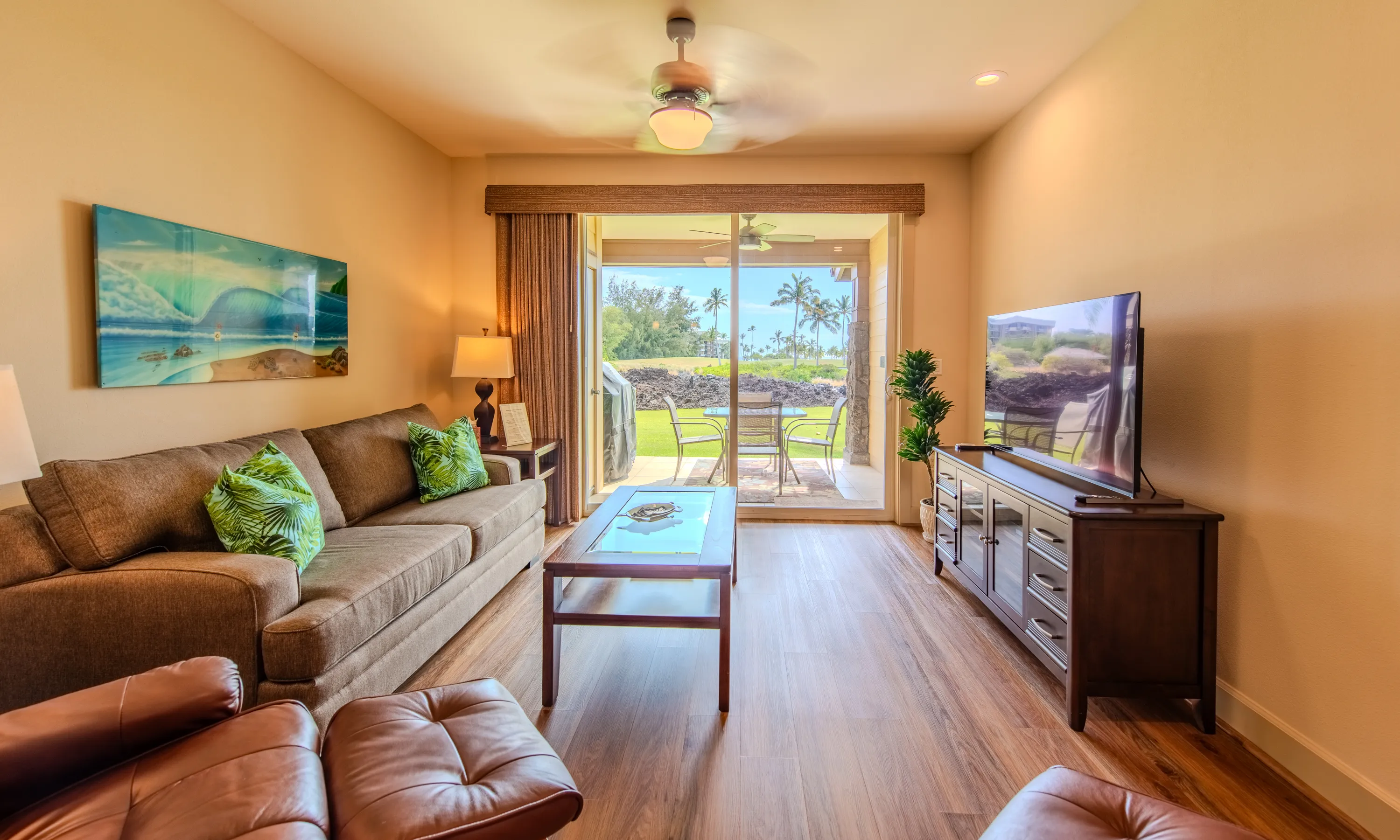 Living room with sofa, leather recliners, and a lanai view
