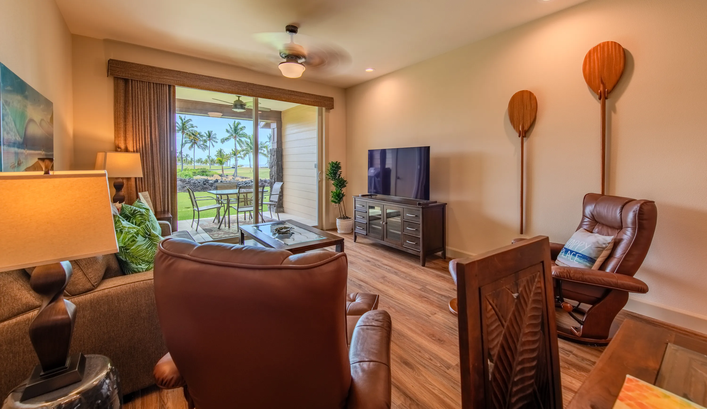 Living room with island artwork and warm wood floors