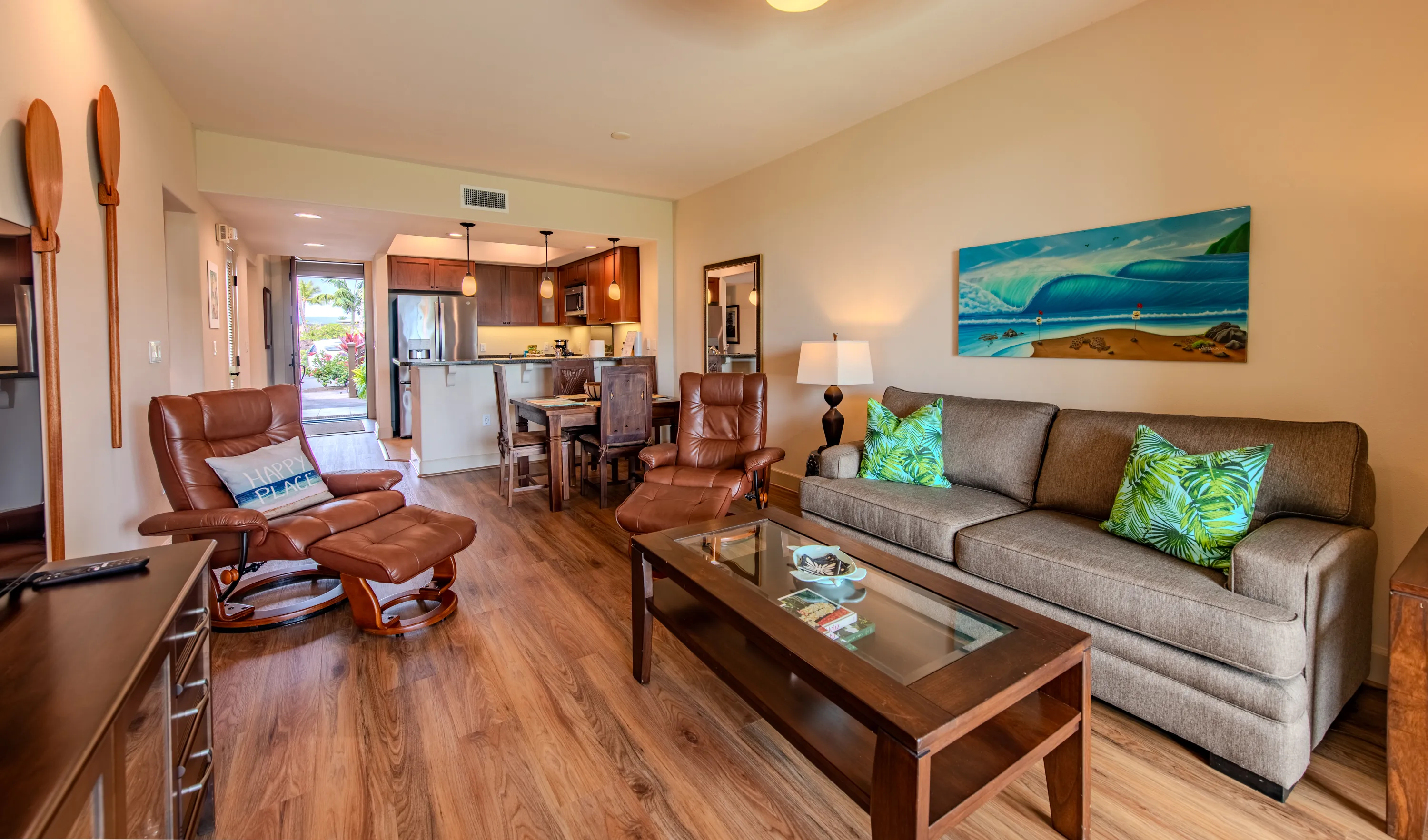 Open great room with living, dining, and kitchen under one bright ceiling