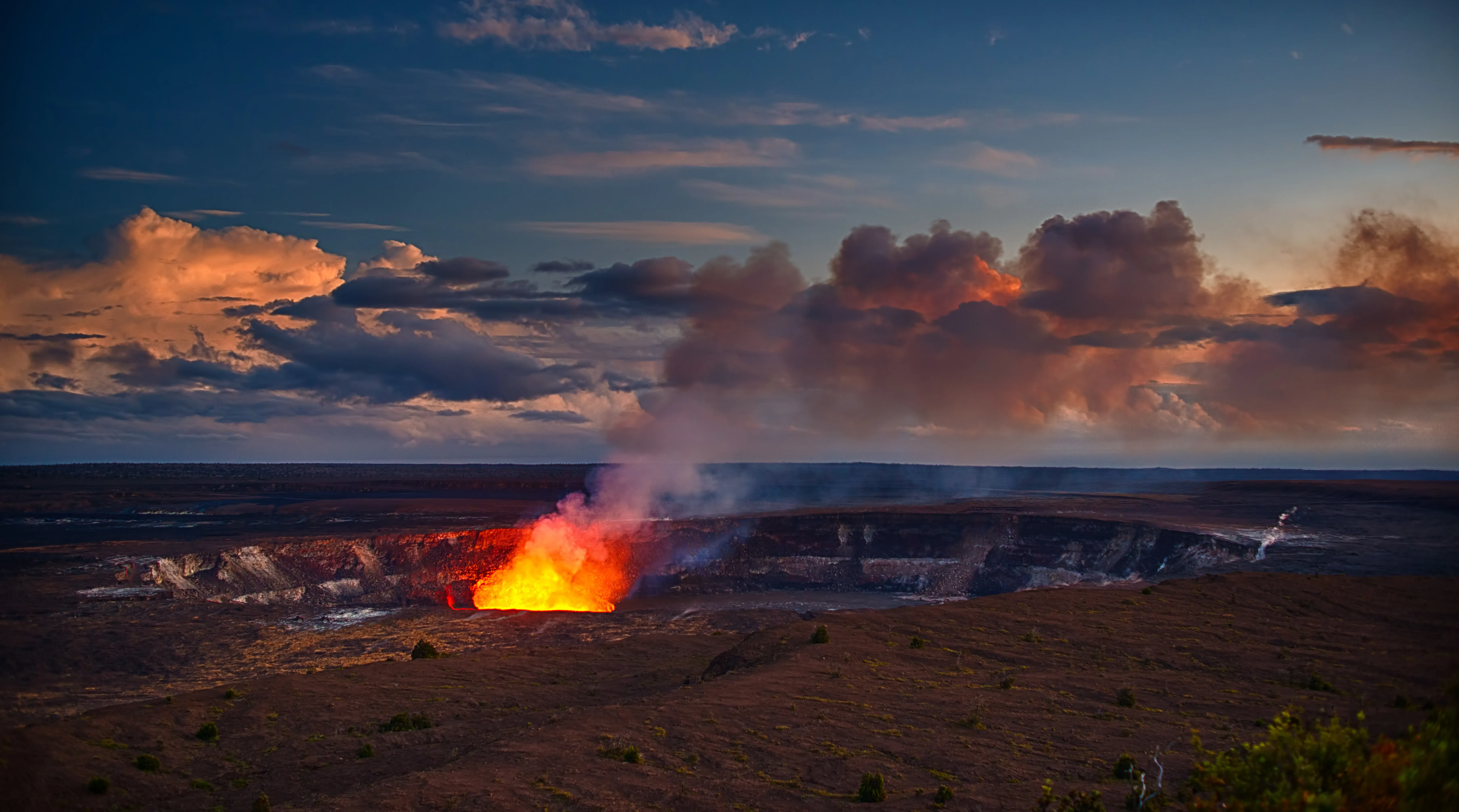 Evening photo of Volcano National Park crater with glowing lava, Volcano, Hawaii.