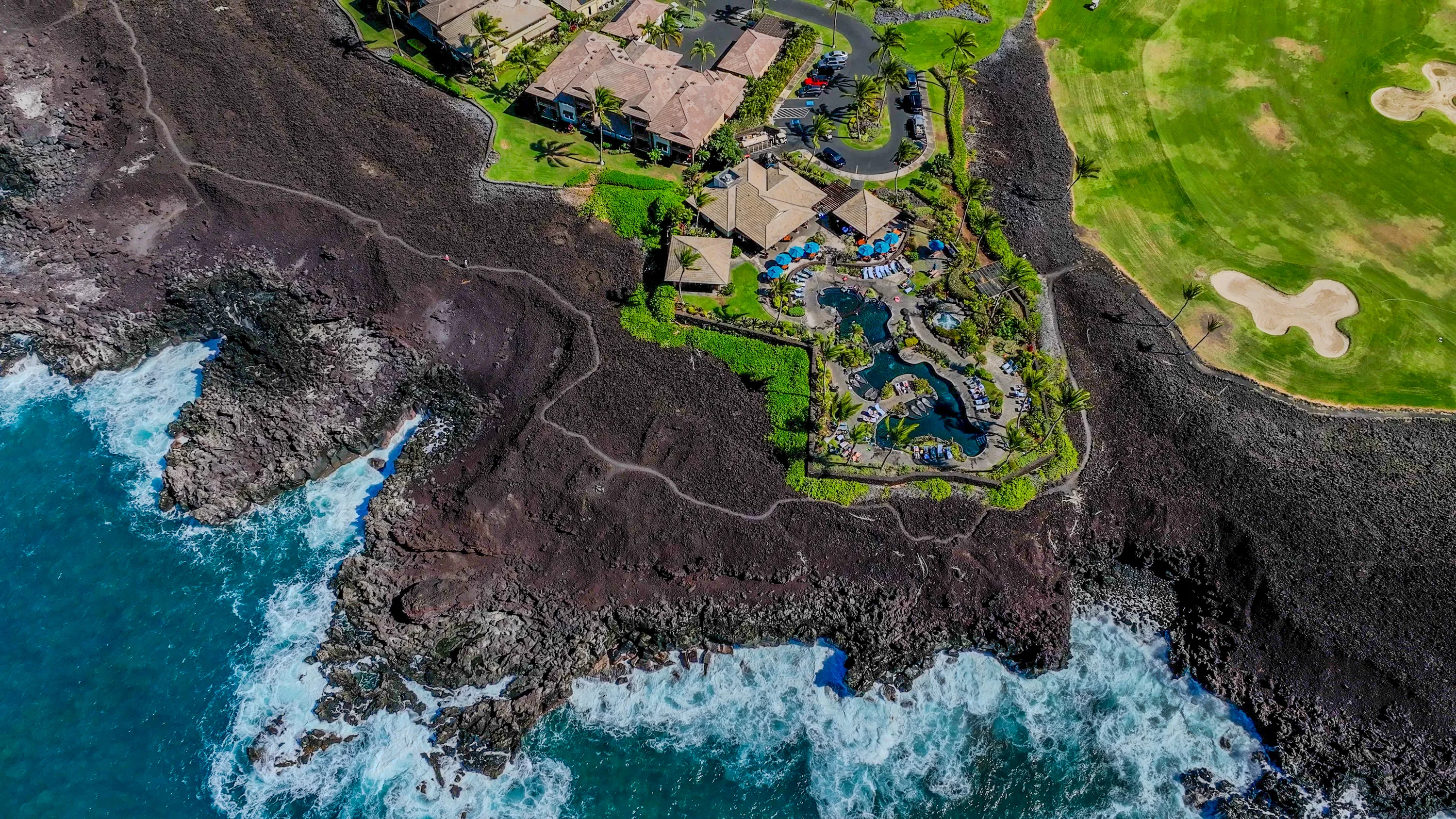 Aerial view of the Ocean Club pools set against the lava coastline