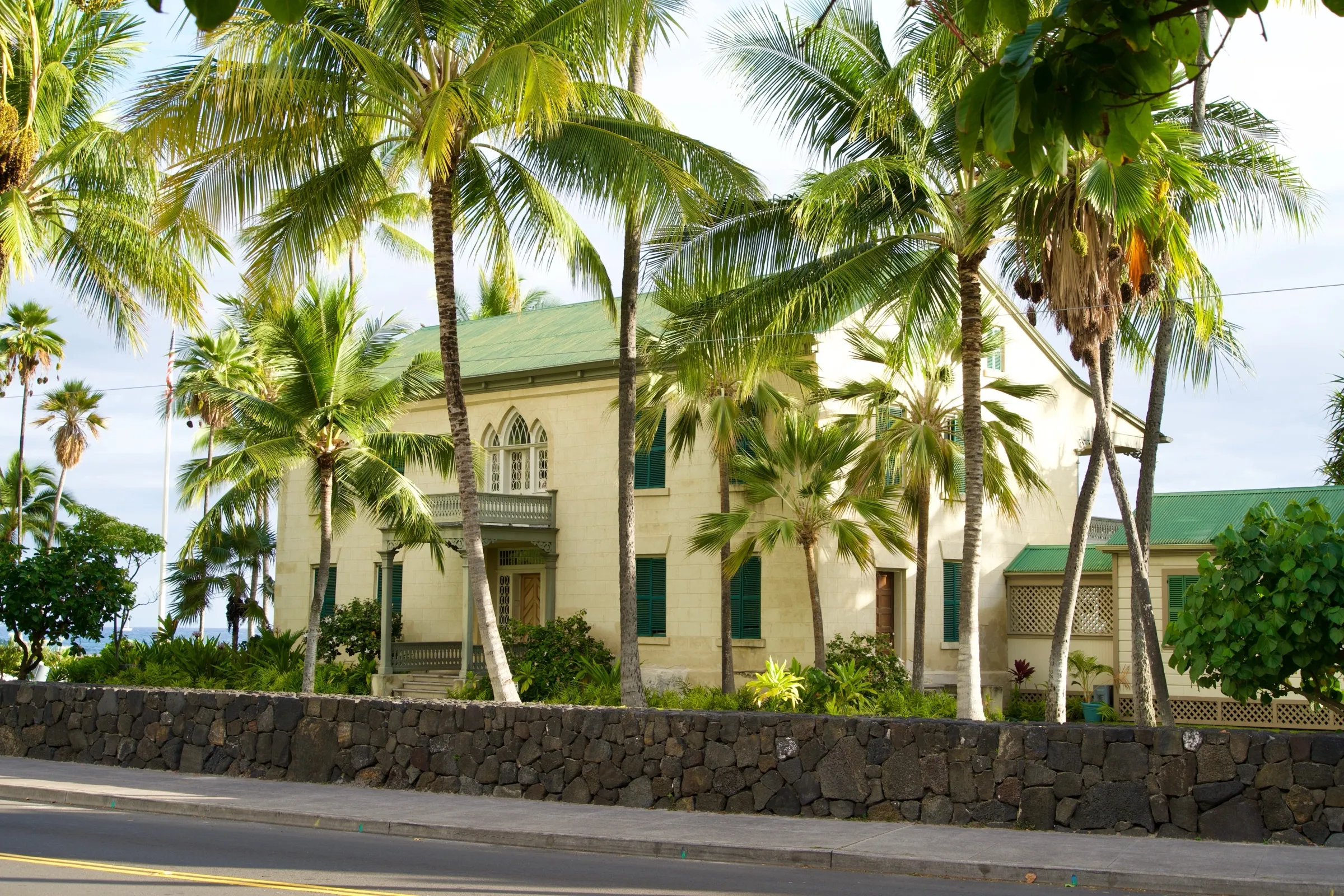 A historic seaside royal palace framed by palms on the Kona coast