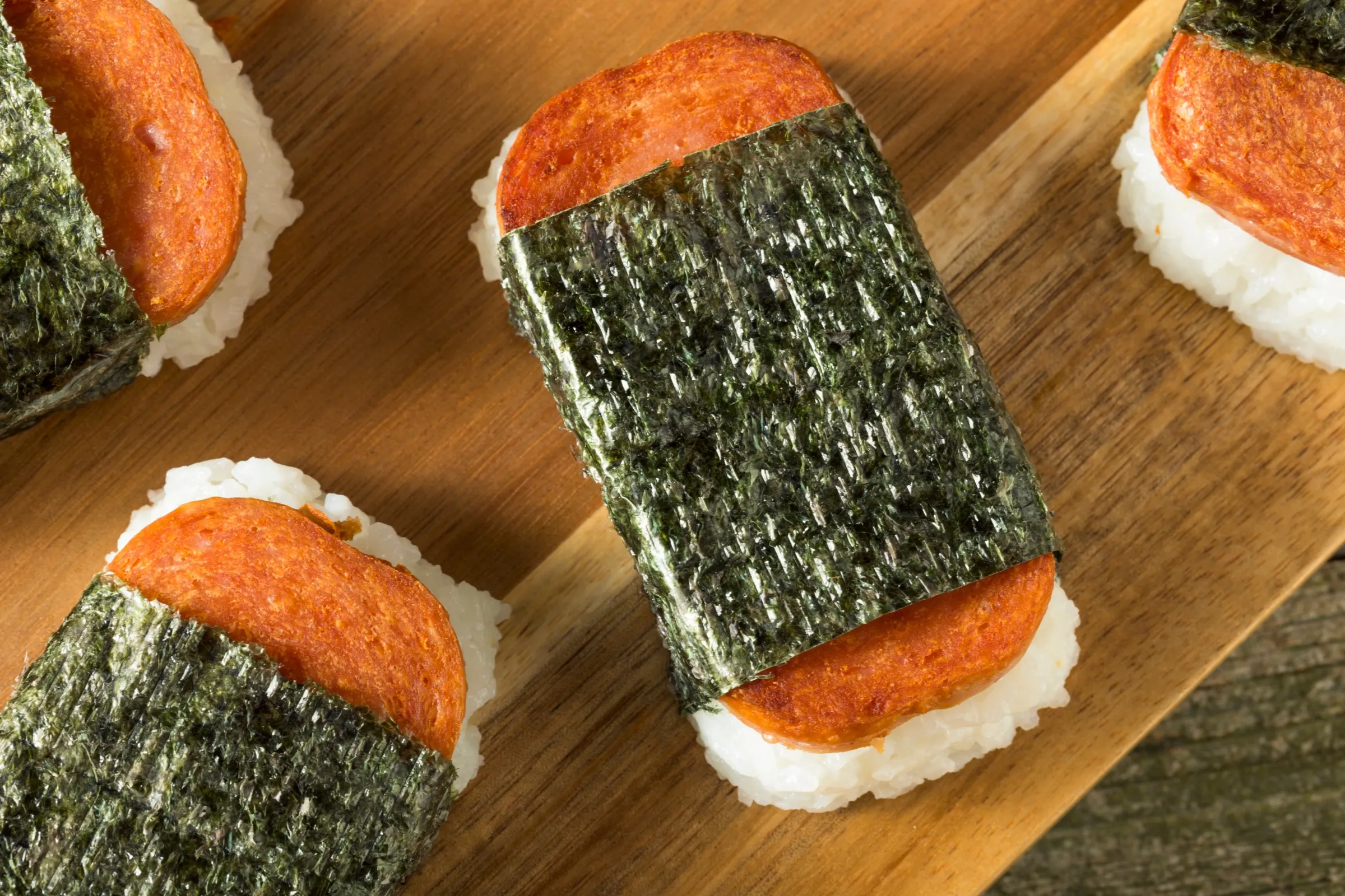 Grilled Spam musubi, a Hawaiian local favorite, on a wooden board