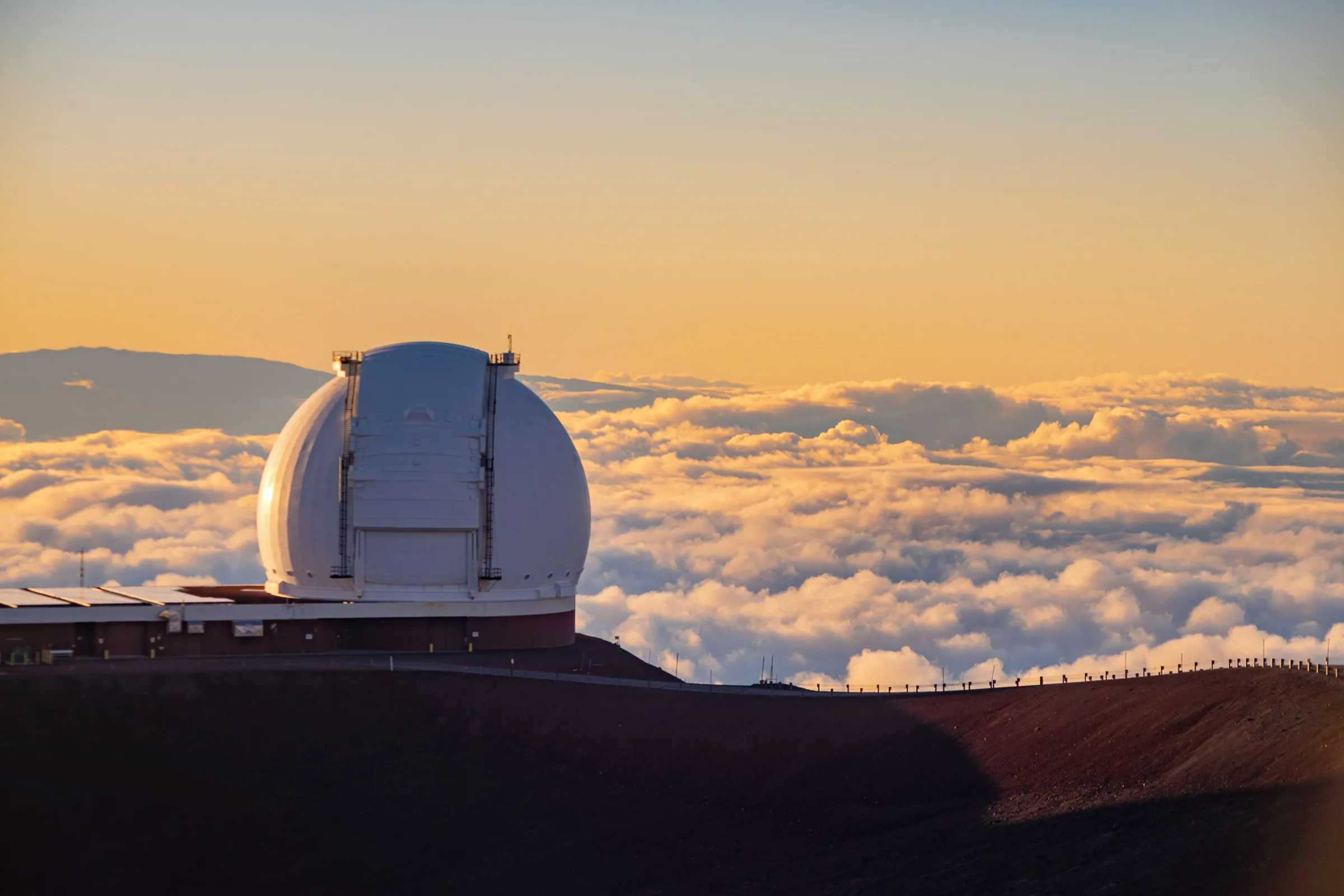 Sunset above a sea of clouds from the summit of Mauna Kea