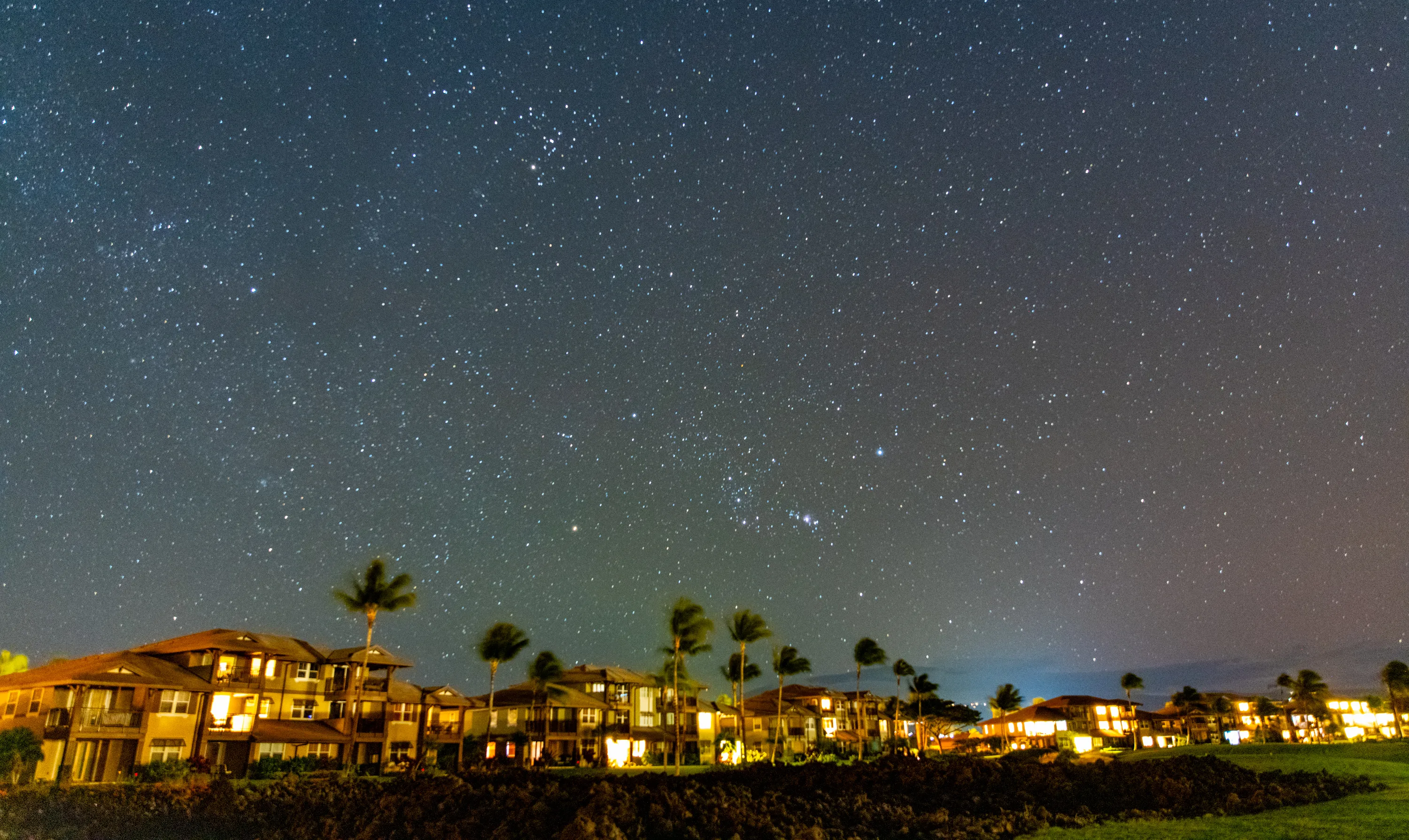 A clear, star-filled night sky over the darkened Kohala Coast