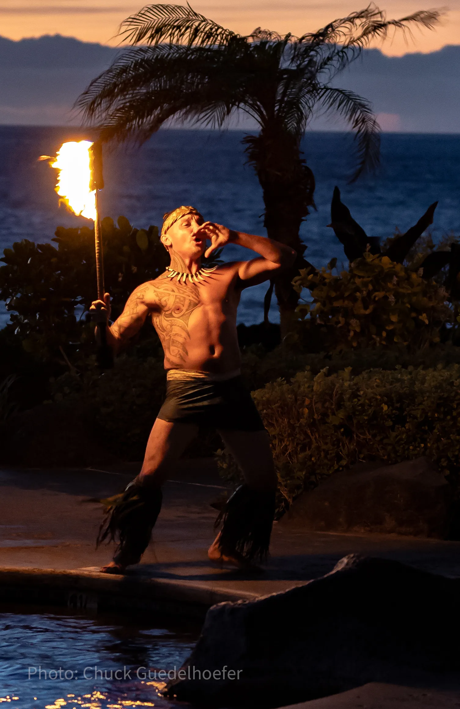 A fire dancer performs at sunset at the Hali’i Kai Ocean Club, Waikoloa Beach Resort.