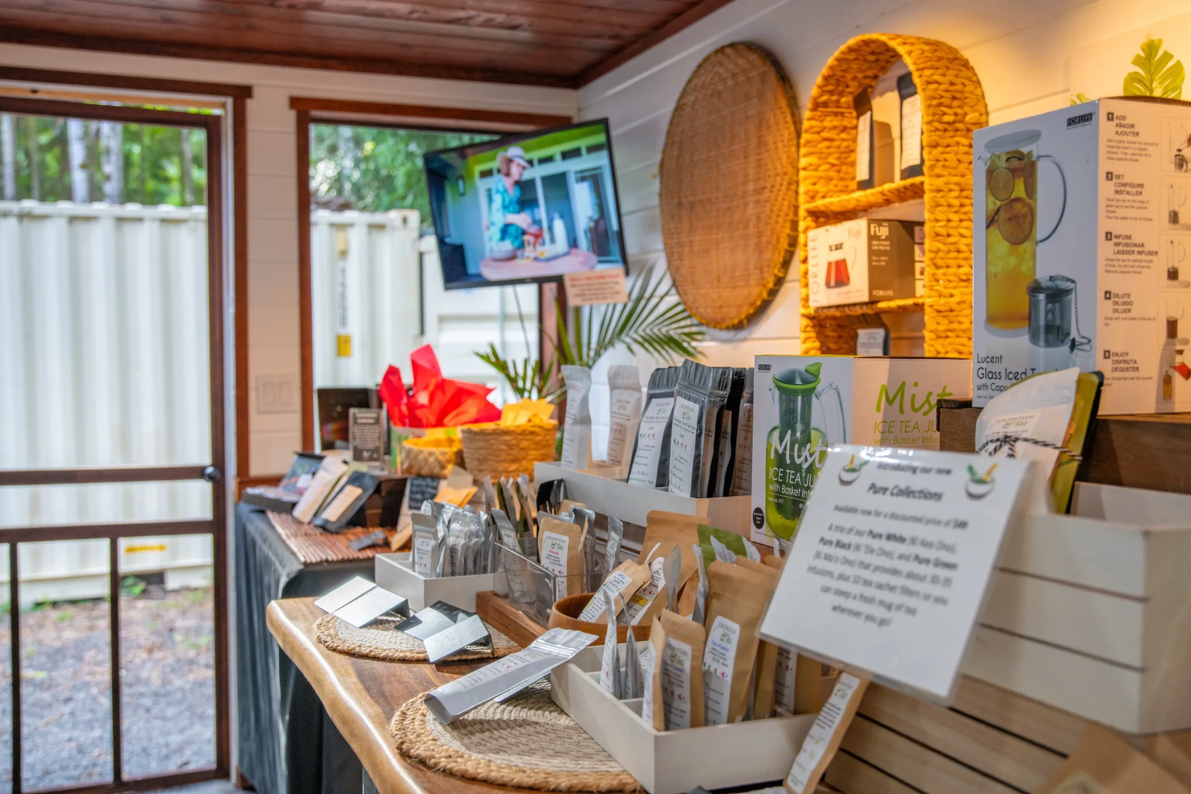 A Big Island tea farm stand with small-batch teas and glass infusers on display
